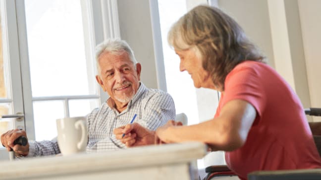 Understanding And Overcoming Behavioral Challenges In Alzheimer'S Memory Care 1 A Senior Couple Smiling Eachother