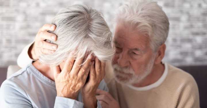 How To Bring Seniors Peace Of Mind When Moving To Dementia Care 1 An Older Man Gently Comforts A Distressed Older Woman Who Is Crying With Her Face In Her Hands.